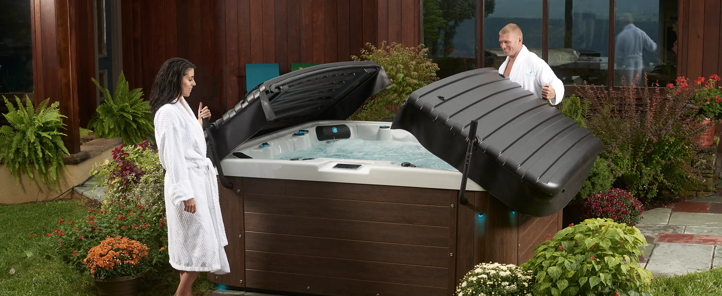 Couple opening a Strong Spa hardcover hot tub